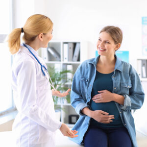 Young pregnant woman discussing IUI vs. IVF in CNJ clinic